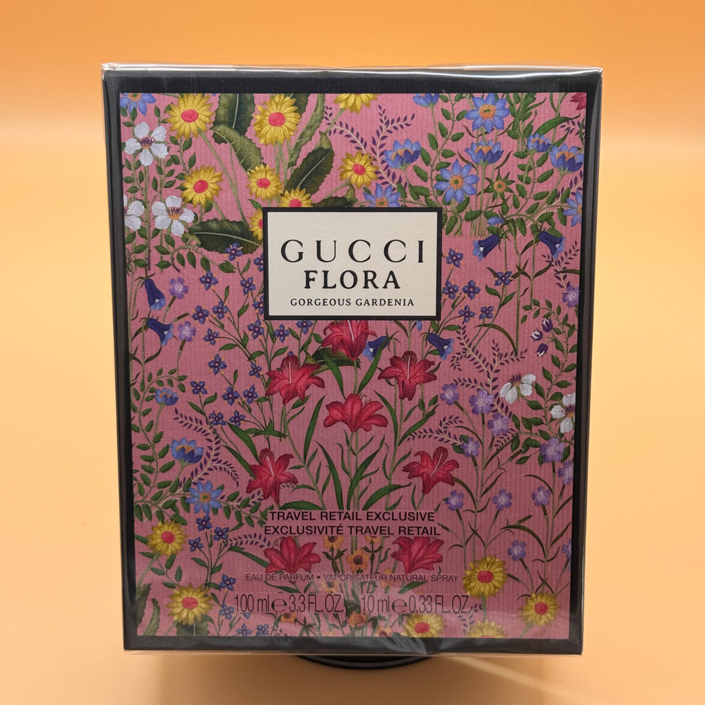 Gucci Flora Gorgeous Gardenia perfume packaging with floral design on a pink background