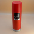 Red Dunhill Desire body spray can on a beige background