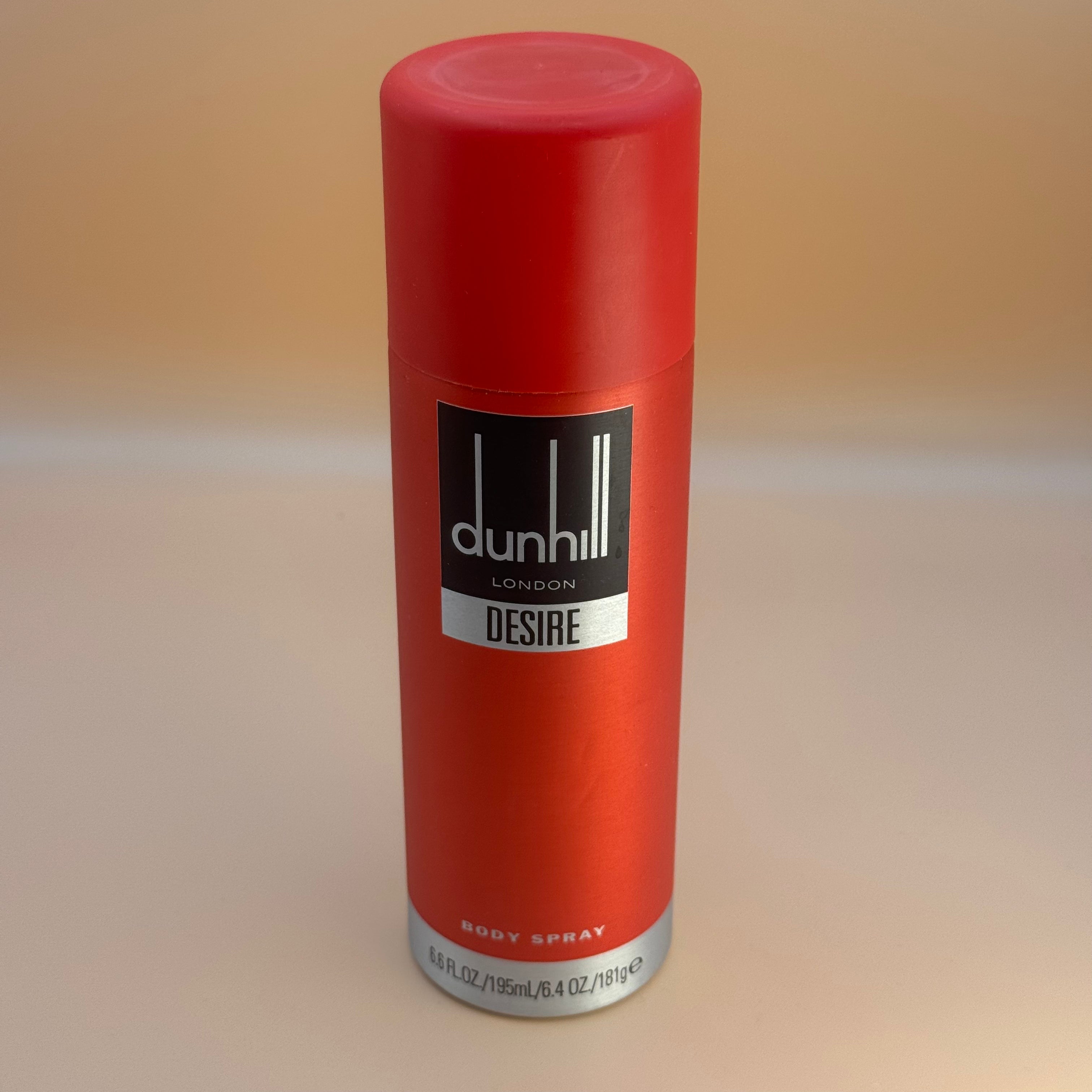 Red Dunhill Desire body spray can on a beige background