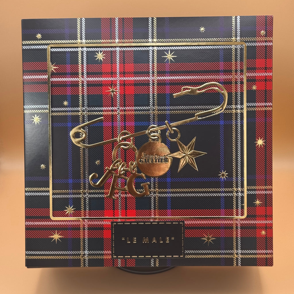 Decorative box with plaid pattern and 'LE MALE' branding on a gradient background