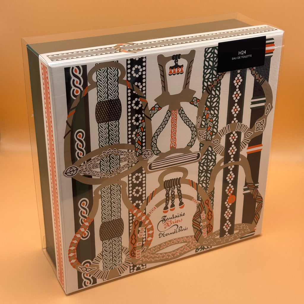 H24 Hermes product packaging with intricate designs on a brown background