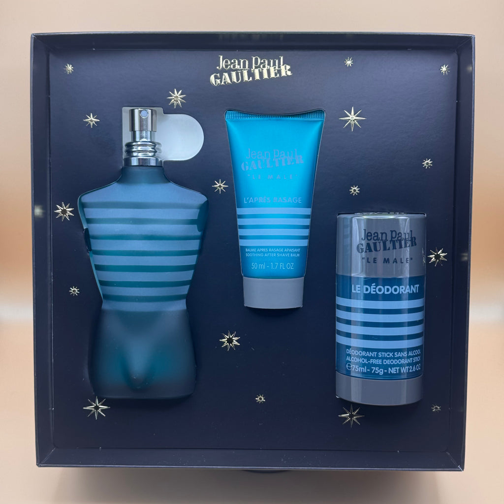 Jean Paul Gaultier perfume set with bottle, after-shave, and deodorant in a decorative box.