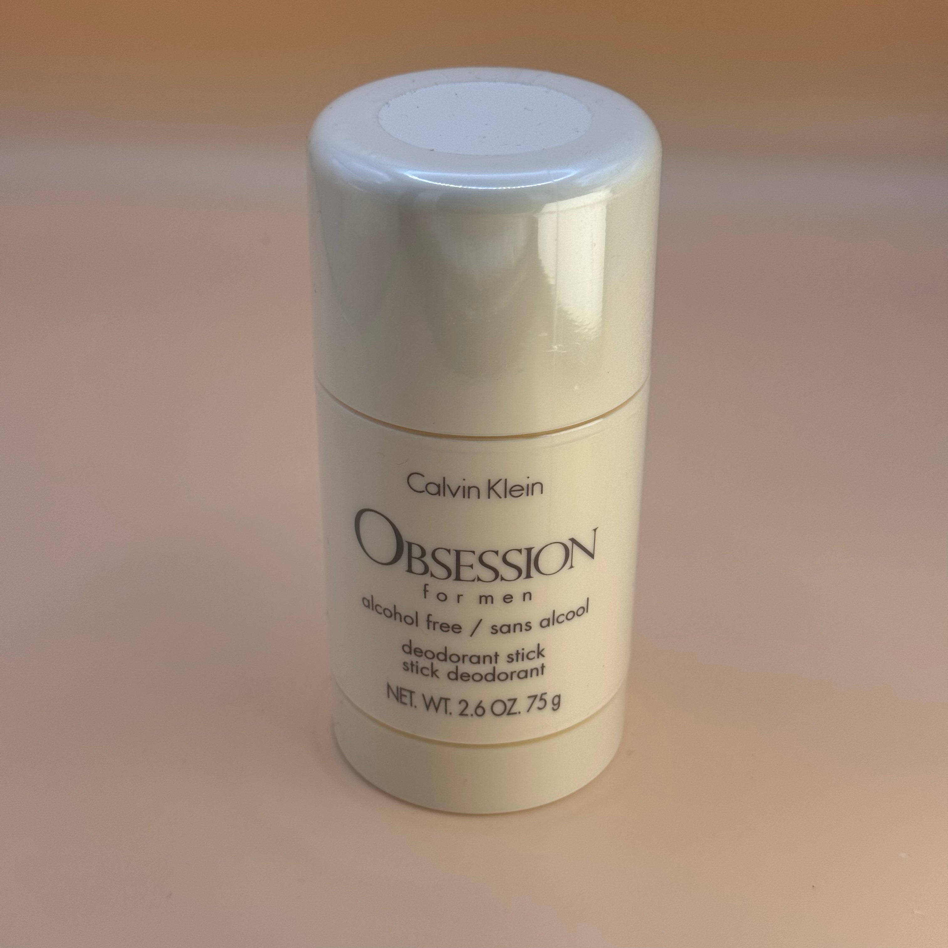 Calvin Klein Obsession deodorant stick on a beige background