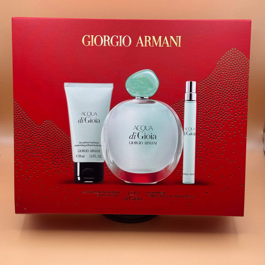 Giorgio Armani Acqua di Gioia perfume set with red box on a peach background